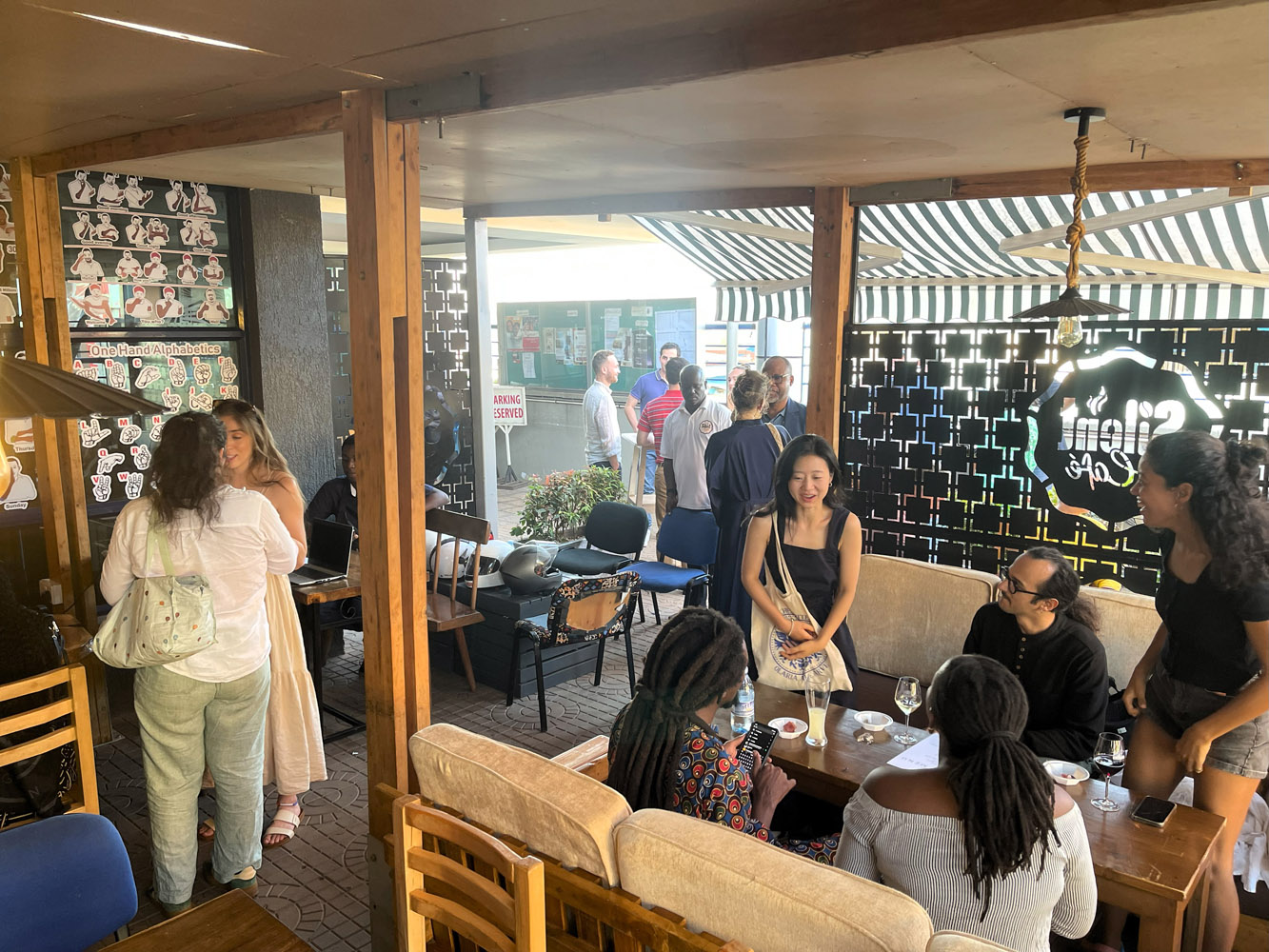 Customers enjoying meals while learning sign language in a welcoming atmosphere