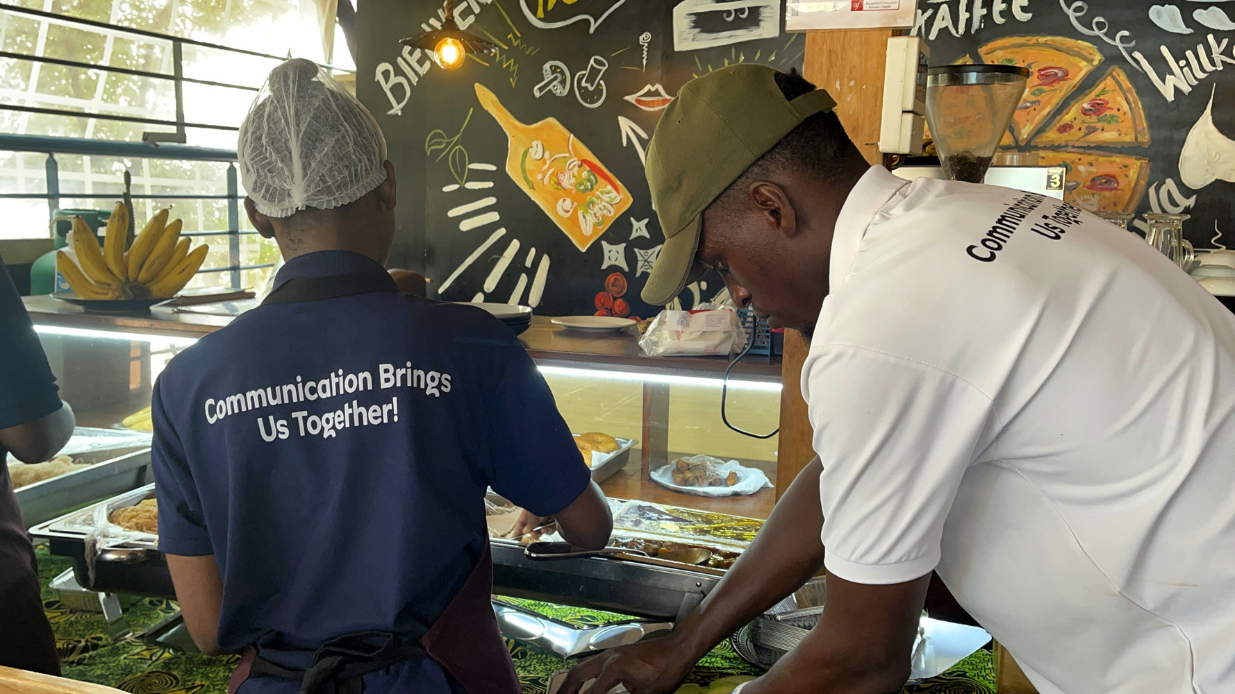 Smiling Deaf barista serving coffee to customers in an inclusive environment