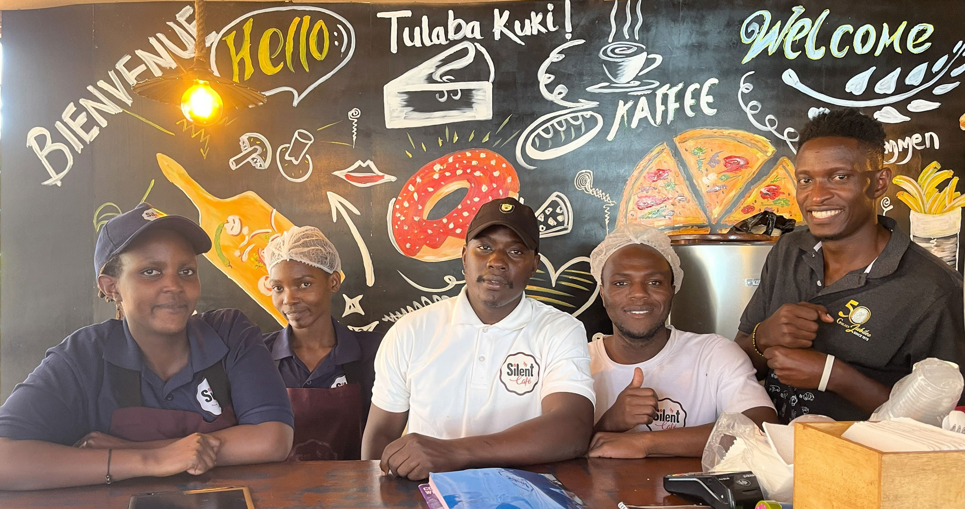 Silent Café team members - a diverse group of Deaf and hearing staff working together in an inclusive environment